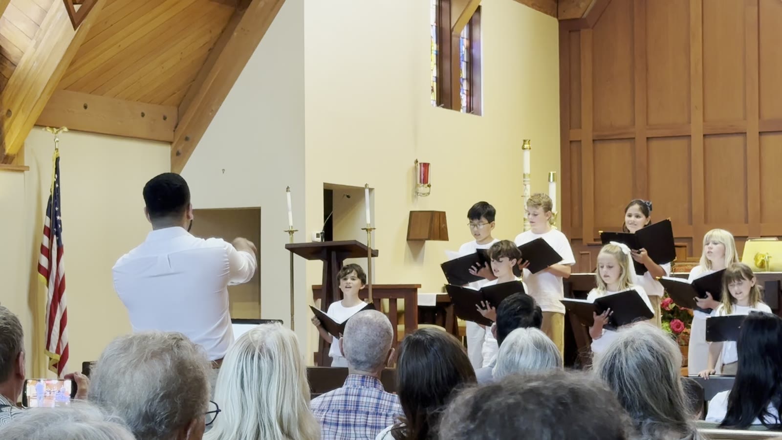 Chorus members standing in a line on the chancel steps